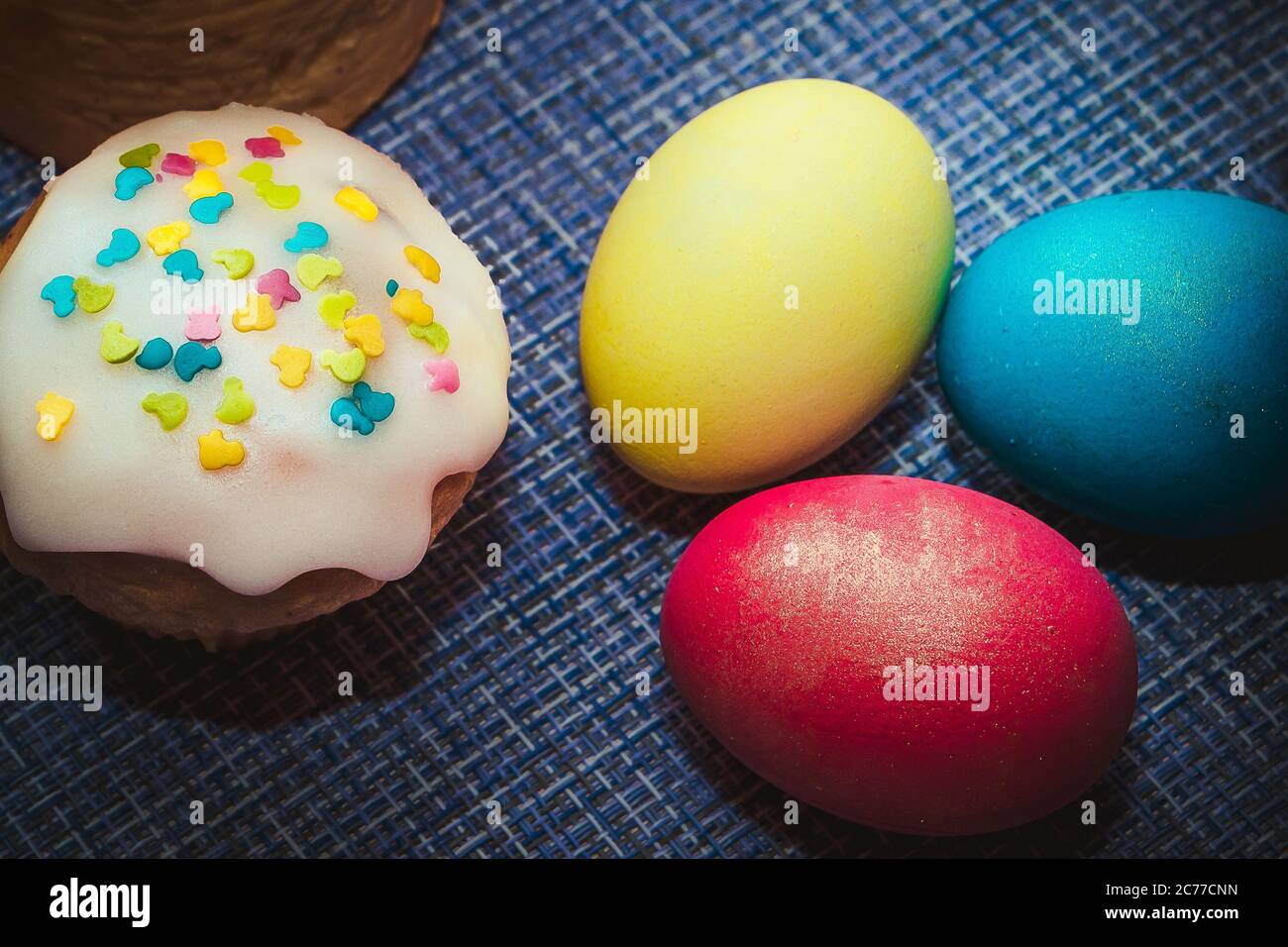 Festive composition - Easter baking and three colored eggs Stock Photo