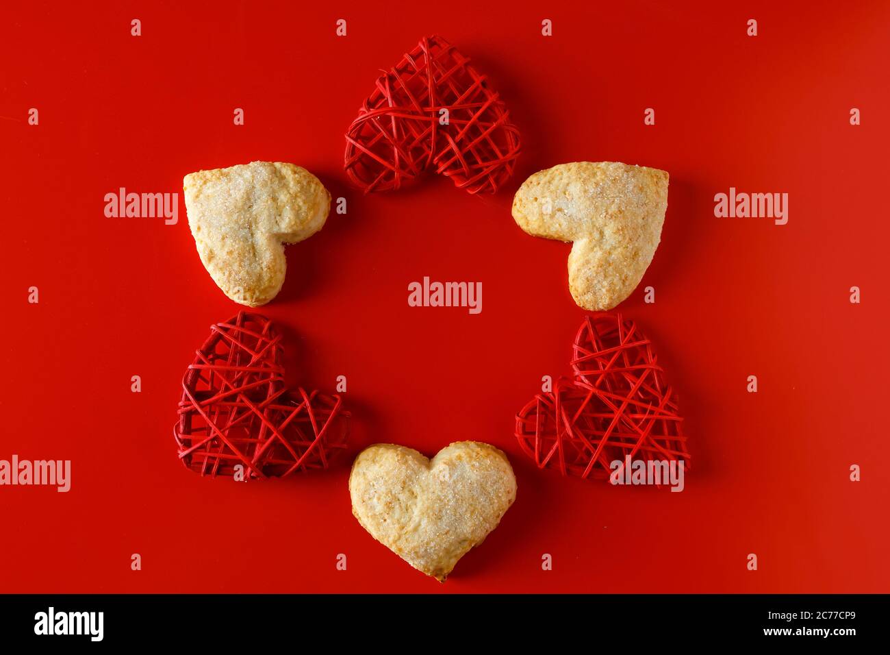 Heart shaped sugar cookies on red background. Composition of cookies in ...