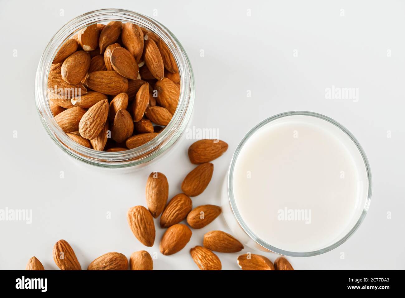 A glass of almond milk on a white background. Lactosefree vegetable diet milk. Gluten free