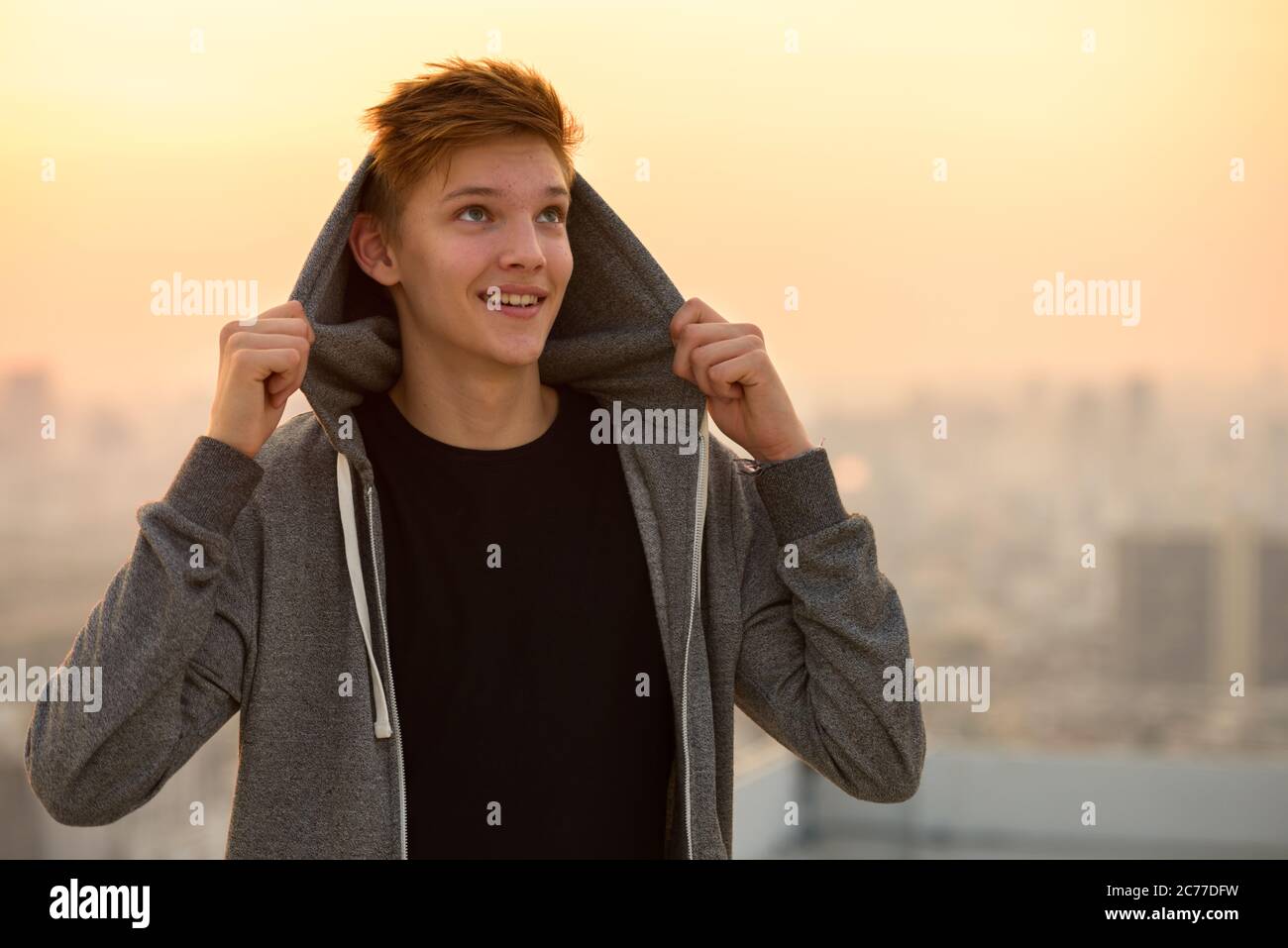 Young handsome teenage boy against view of the city outdoors Stock ...
