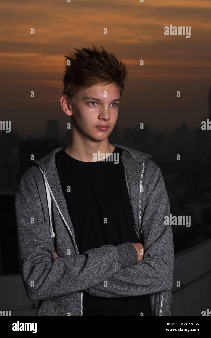 Young handsome teenage boy against view of the city outdoors Stock ...