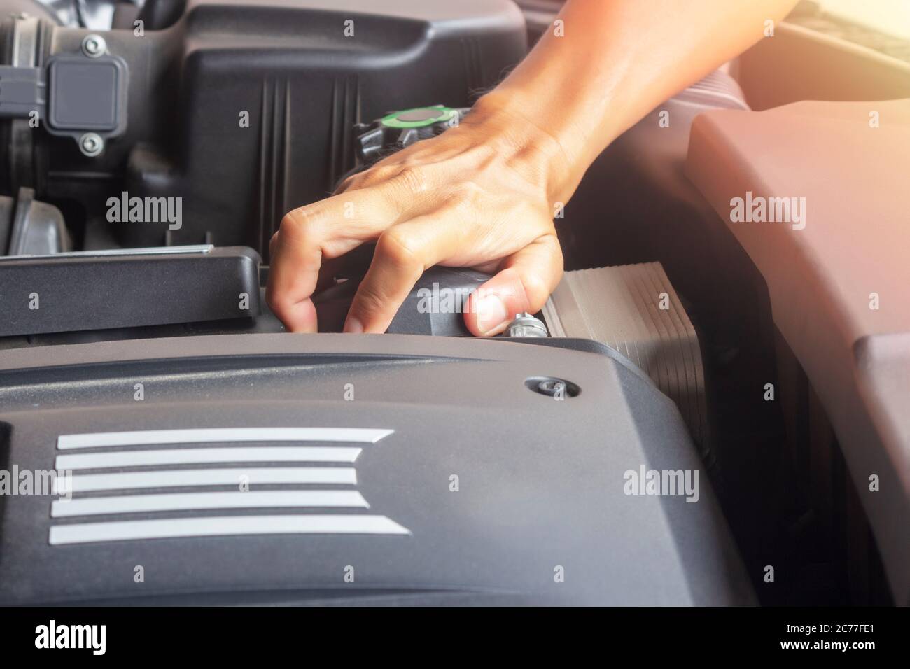 Hands of mechanic working in auto repair shop Professional check oil filter and close oil filter cap Stock Photo