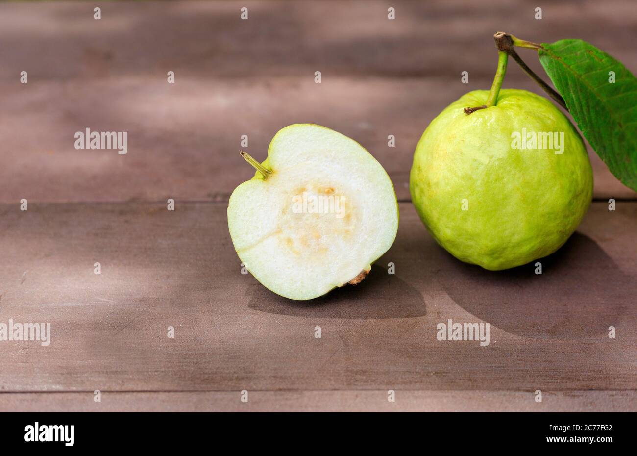 Fresh guava fruit on wood table with sun ray. Fresh guava slide Stock