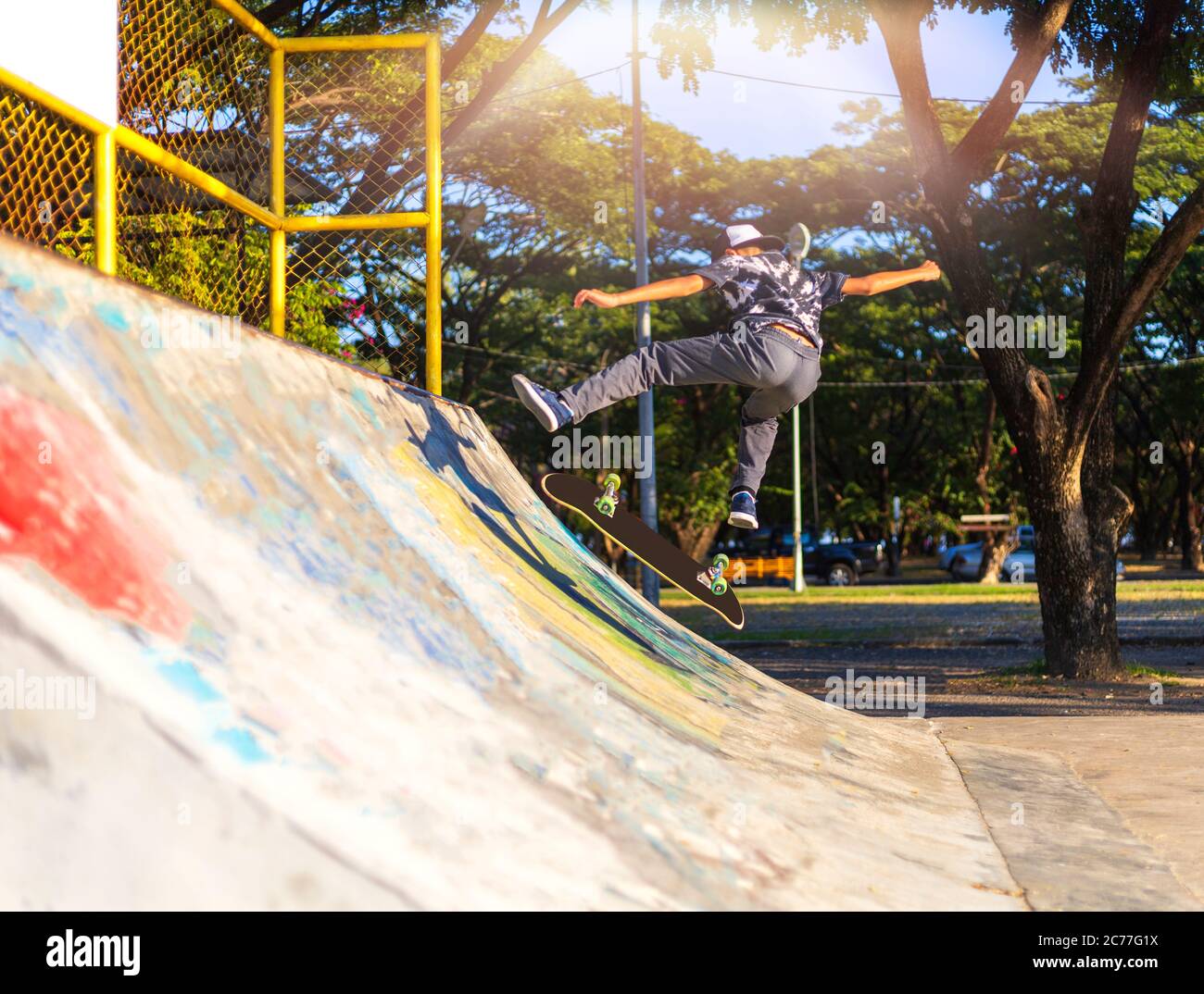Young boy jump on ramp with skateboard outdoor Stock Photo - Alamy