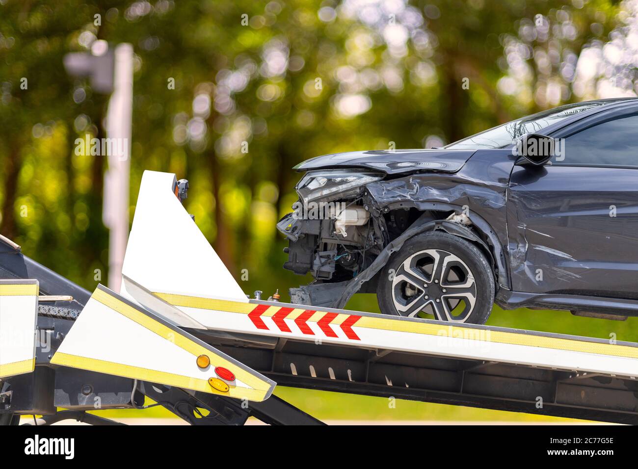 accident Car Slide on truck for move. Black car have damage by accident