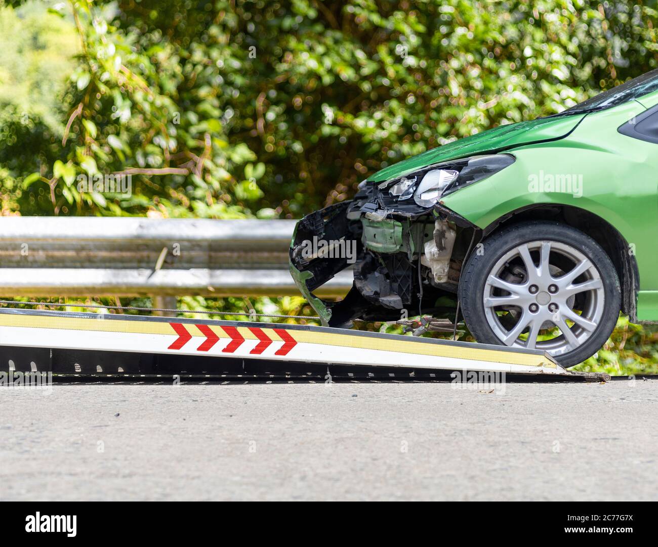 accident Car Slide on truck for move. Green car have damage by accident