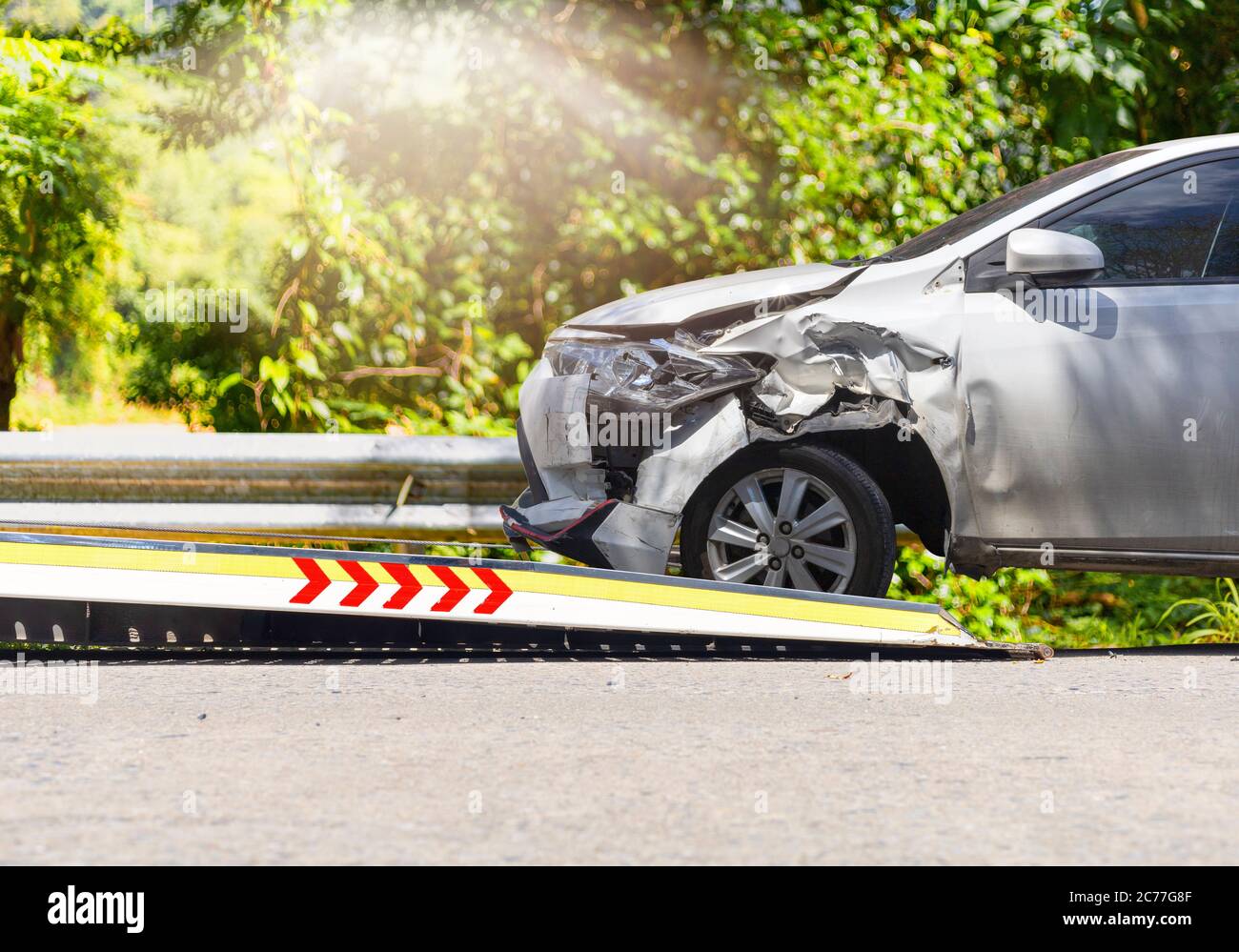 accident Car Slide on truck for move. White car have damage by accident