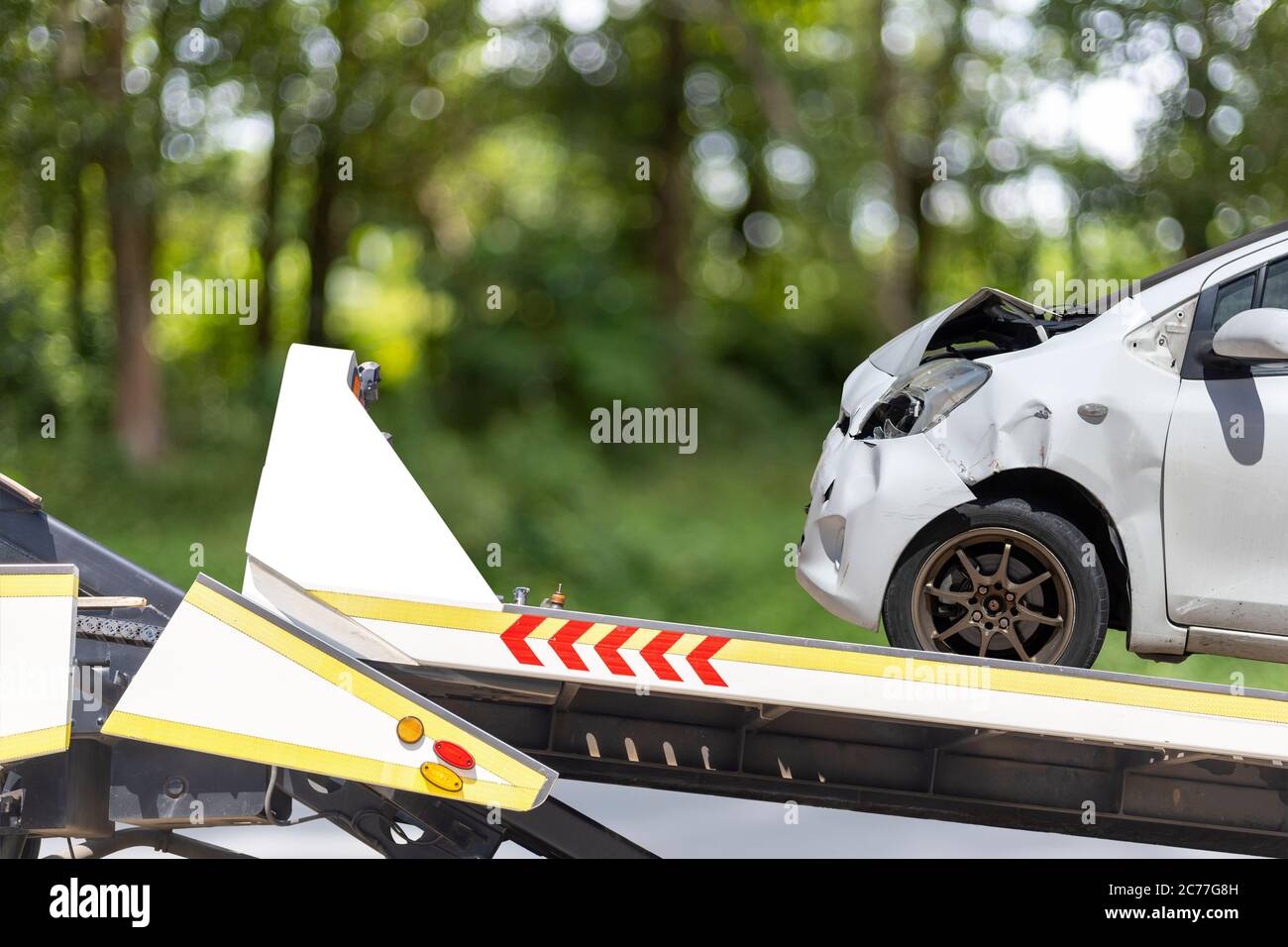 accident Car Slide on truck for move. White car have damage by accident