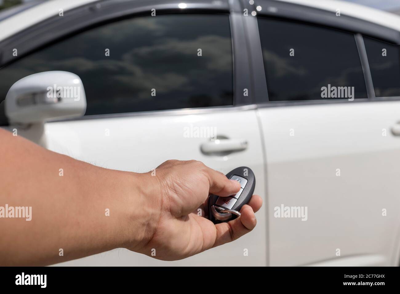 Hand man hold button unlock on the car remote control for unlock door