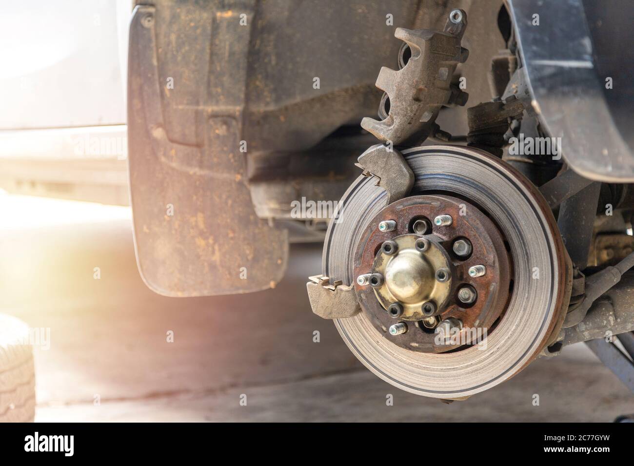 Front disc brake on car with brake caliper process of new tire