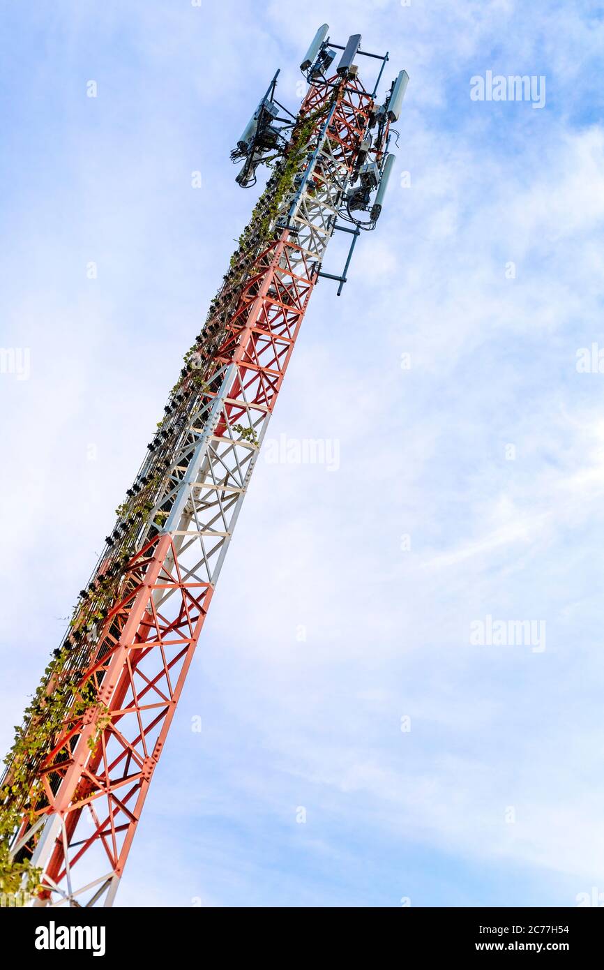 mobile phone communication and network signal repeater antenna tower with blue sky background Stock Photo