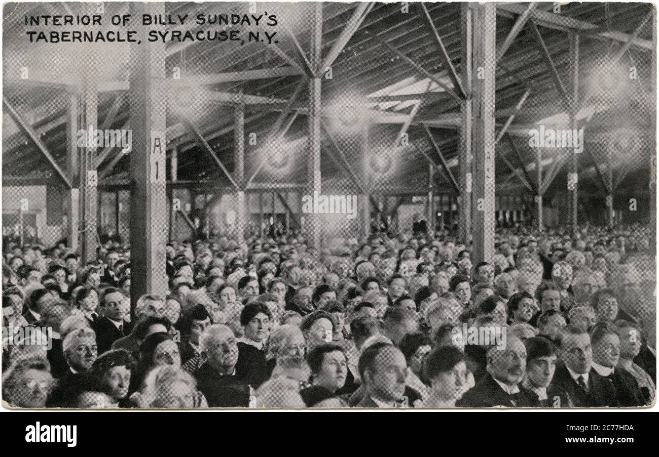 Vintage 1915 postcard of the interior of Billy Sunday's Tabernacle in Syracuse, New York. Billy (William Ashley) Sunday (1862–1935) was a popular outfielder in baseball's National League during the 1880s who became the most celebrated and influential American evangelist during the first two decades of the 20th century. Stock Photo