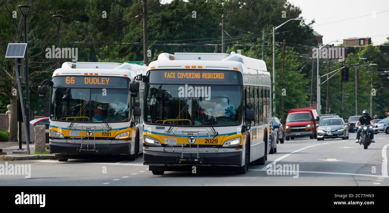 ‘Face Covering Required’ sign on the front of a Massachusetts Bay Transportation Authority (MBTA) bus as it travels away from the Cambridge Common in Cambridge, Massachusetts. Stock Photo