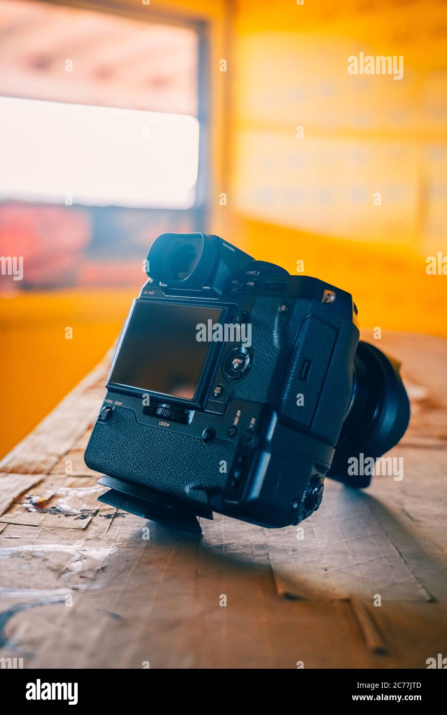 Black DSLR camera on a wooden table. Stock Photo