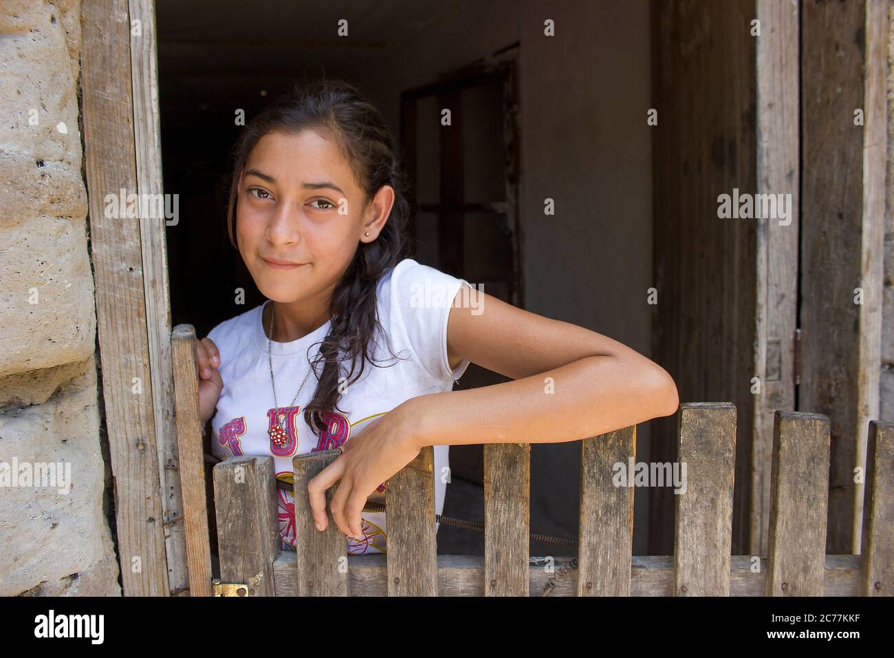 Beautiful young girl in rural house in Honduras with a peaceful smile. Stock Photo
