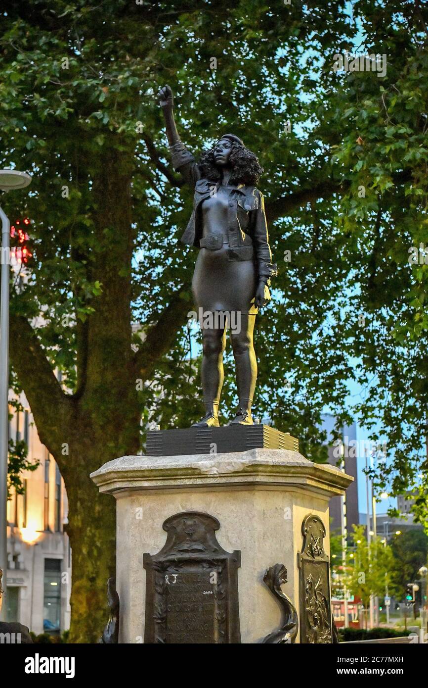 A black resin and steel statue titled A Surge of Power (Jen Reid) 2020, by Marc Quinn is installed on the vacant Edward Colston plinth in Bristol city centre. Stock Photo