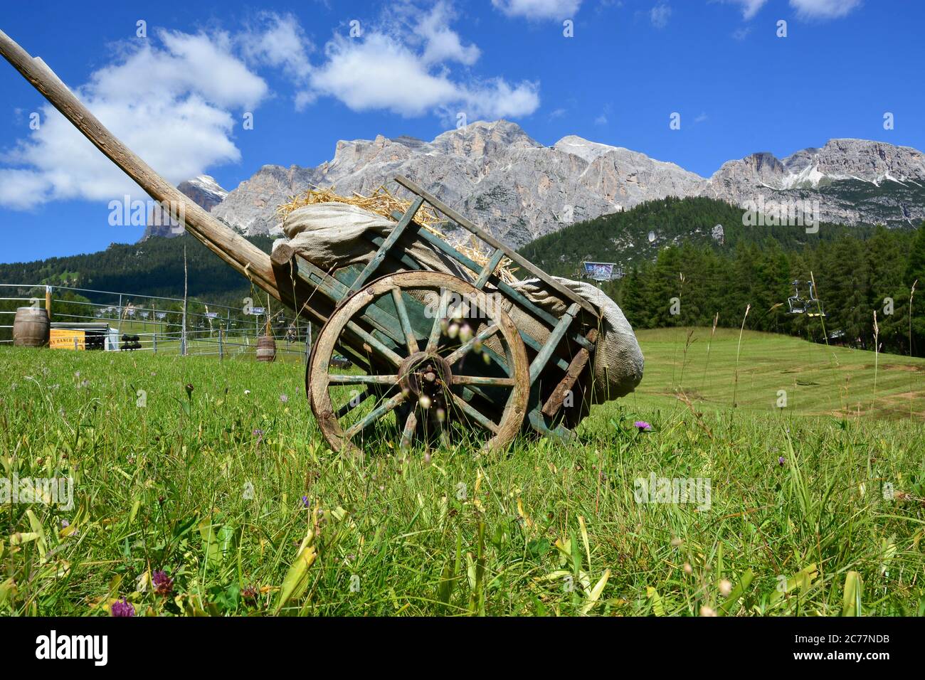 a wagon of hay and straw under Le Tofane, in Cortina d'Ampezzo, Italy Stock Photo
