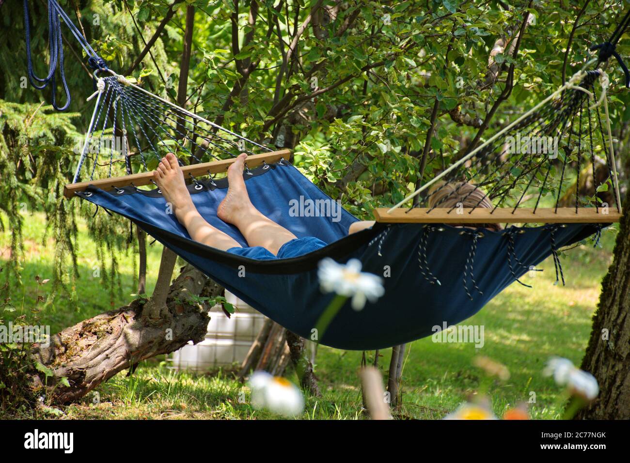 Woman relaxing in hammock during summer holidays Stock Photo