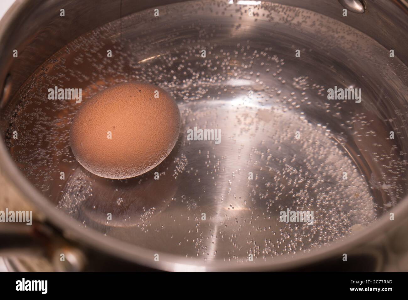 The egg is cooked in a saucepan, large Stock Photo