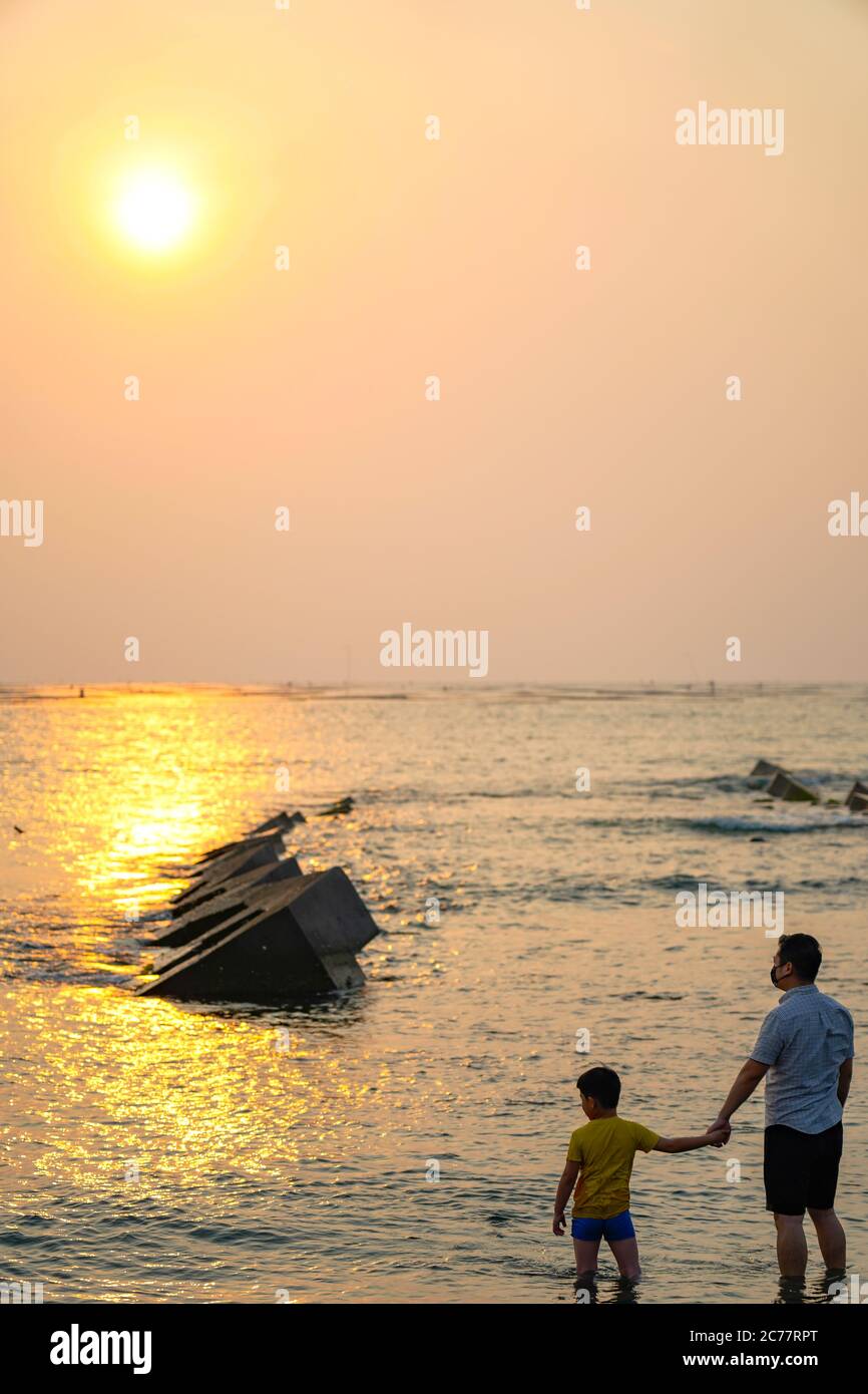 Happy asian family playing at the beach hi-res stock photography and ...