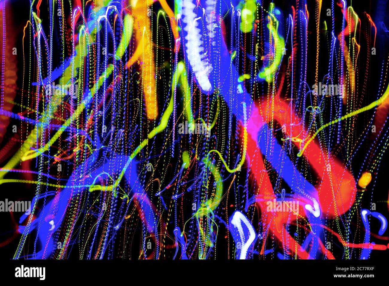 Christmas lights in blurry focus and motion long-exposure photo. Abstract background. Swirl effect. New year, power energy, LED, sci-fi, neon, magic, Stock Photo