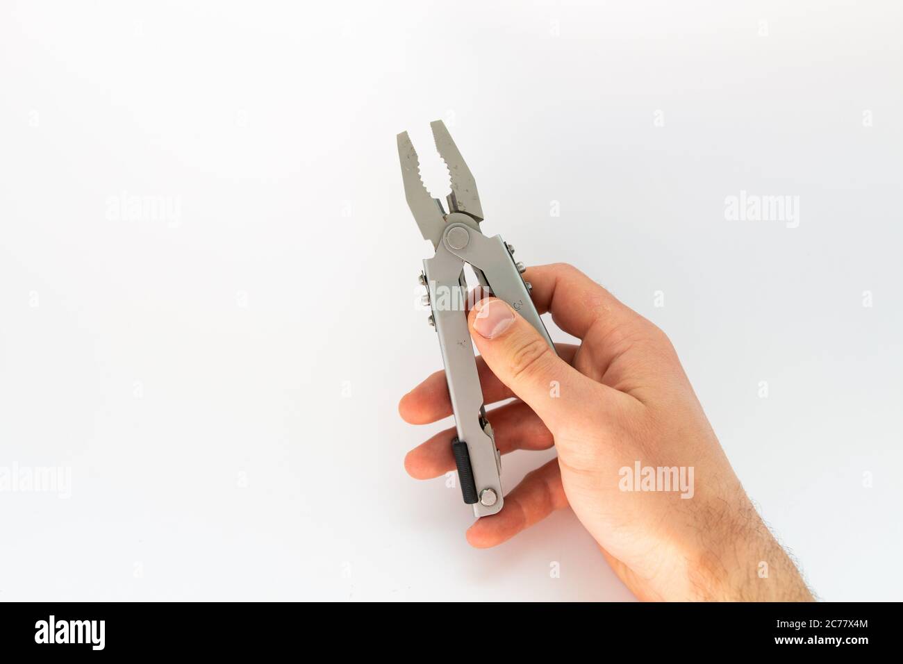 pliers in hand on white background Stock Photo