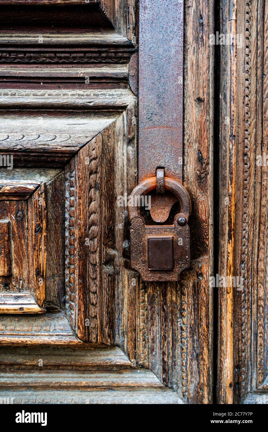 Old rusty lock on an old wooden door close-up. Vertical frame Stock ...