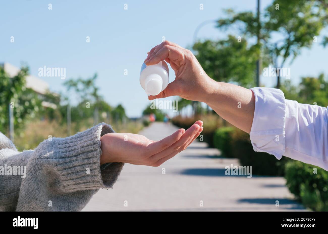 Pouring disinfectant gel on the street, washing your hands with disinfectant gel. Disinfectant gel. Washing your hands. Disinfectant with alcohol. Doc Stock Photo