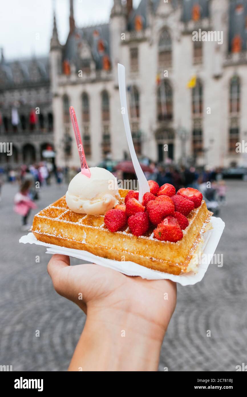 Traditional Belgian dessert. Waffle with strawberry and cream. Belgian