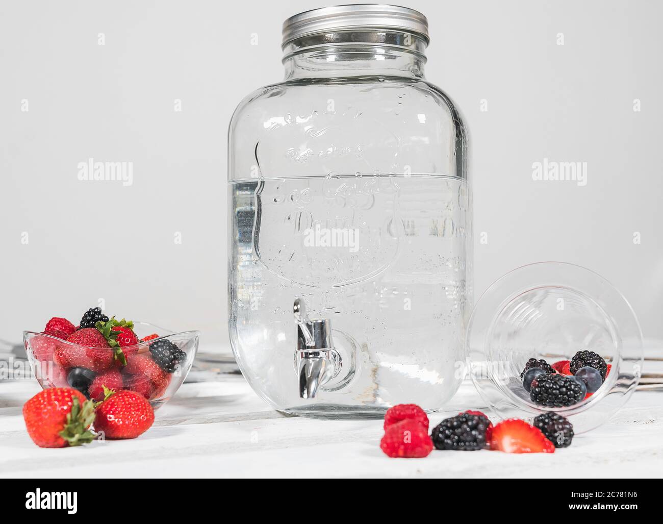 Glass of water flavored with berries. Red fruit flavoured water