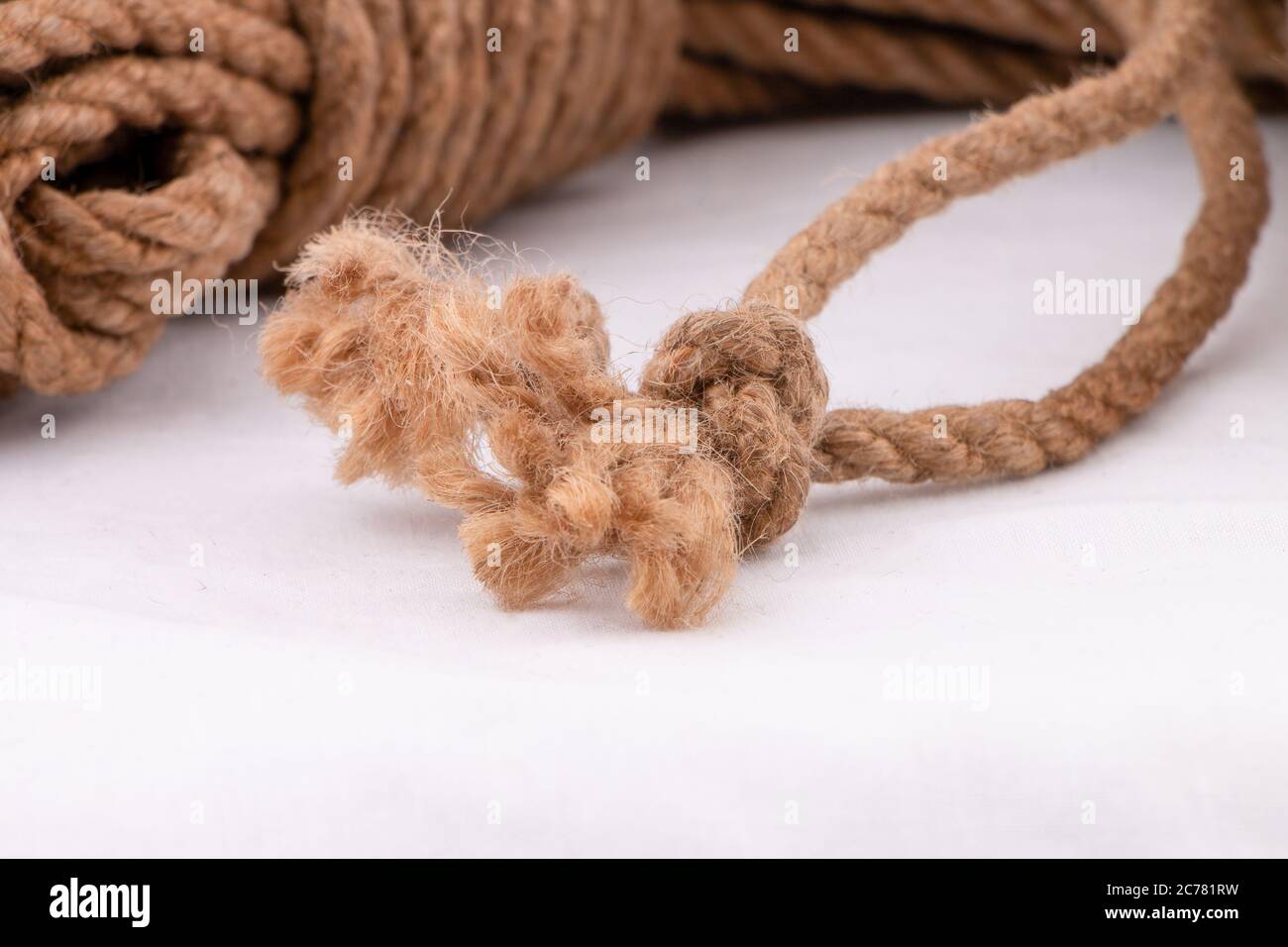Coiling rope starting with ends and bight locked with tuck under wraps Stock Photo