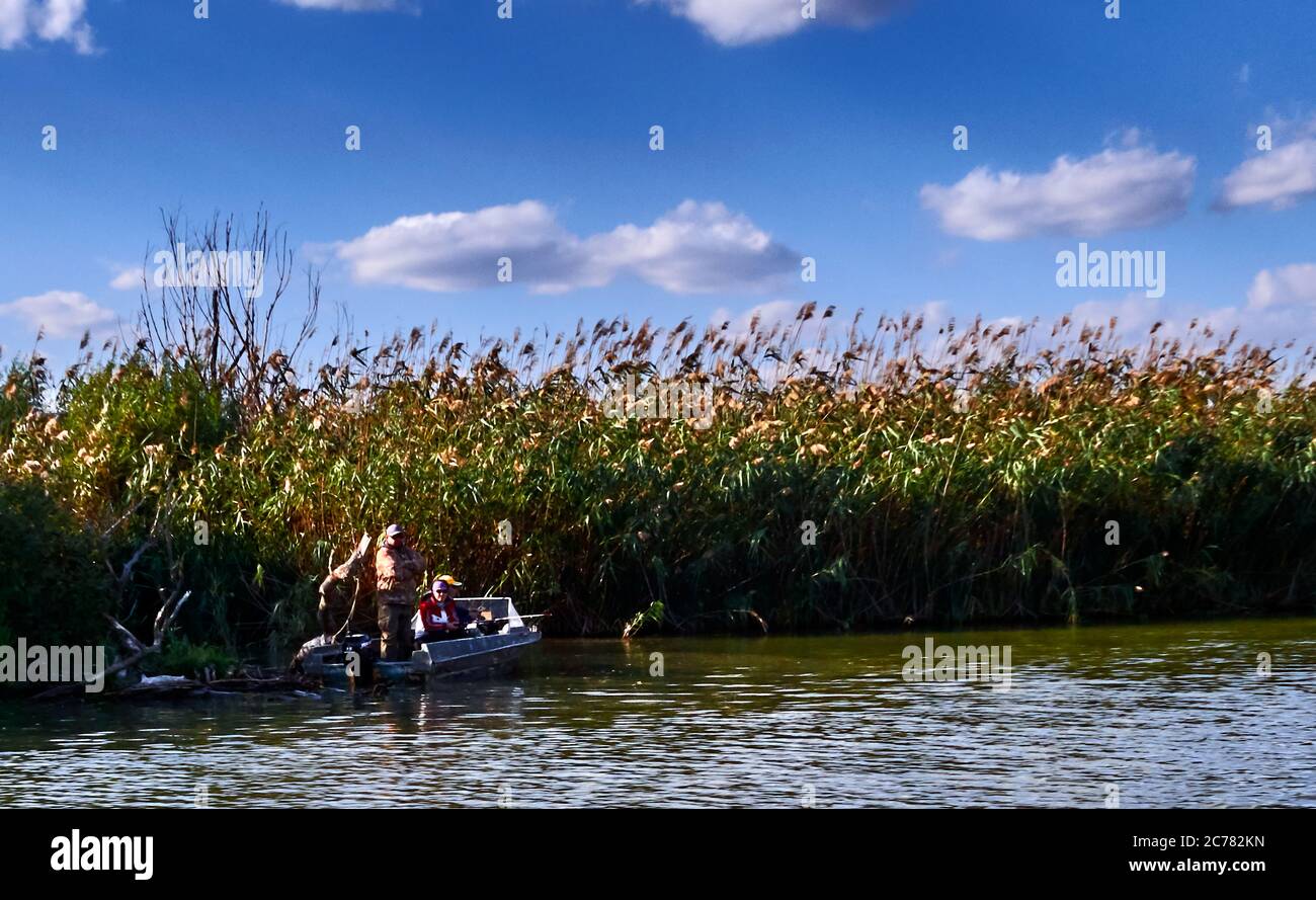 Russia, Astrakhan Oblast,      fisherman at the linein a  Fishing boat in the Volga estuary near the Caspian Sea Stock Photo