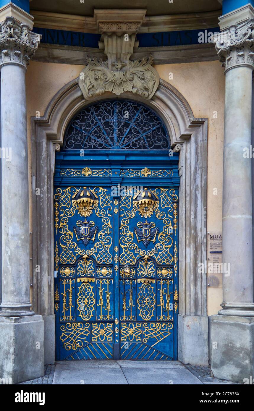 Poland, Wroclaw city,province of Lower Silesia, This wonderfully ornate blue and gold vintage wooden door is one of the unique entrances to the University of Wroclaw Stock Photo