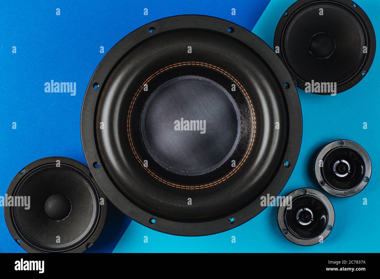 Car audio, car speakers, black subwoofer on a bluelight blue