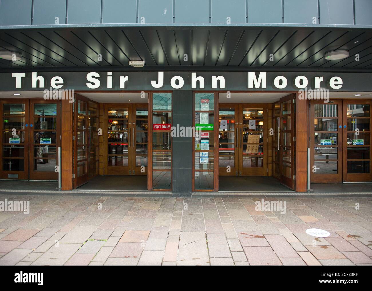 Glasgow, Scotland, UK. 15th July, 2020. Pictured: Wetherspoons pub chain, The Sir John Moore pub in the centre of Glasgow, prepares for the influx of customers. They have social distancing signs and markers and also hand sanitising stations in the foyer area so that customers may wash their hands. Wetherspoons are taking seriously the issue of social distancing and cleanliness very seriously. Credit: Colin Fisher/Alamy Live News Stock Photo