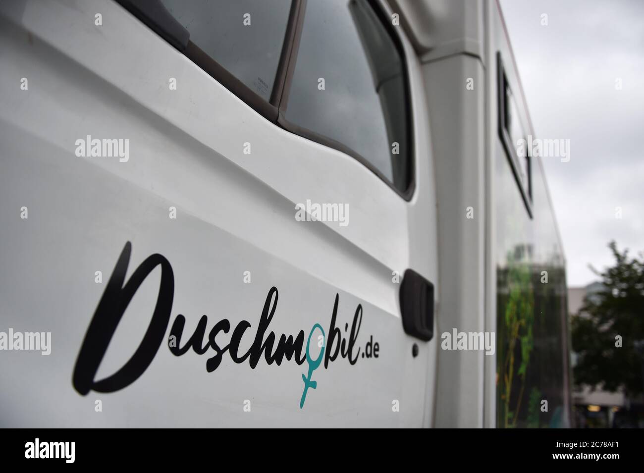 15 July 2020, Berlin: The logo of the shower-mobile for homeless women operated by the Sozialdienst katholischer Frauen e.V. is attached to the driver's door of the vehicle. Photo: Sven Braun/dpa Stock Photo