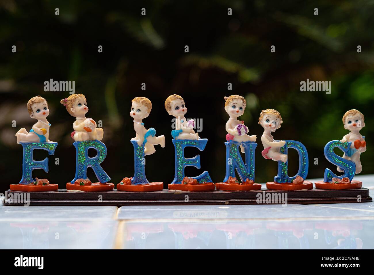 Ceramic dolls on each letter that spells as friends. A very beautiful souvenir for friends. Stock Photo