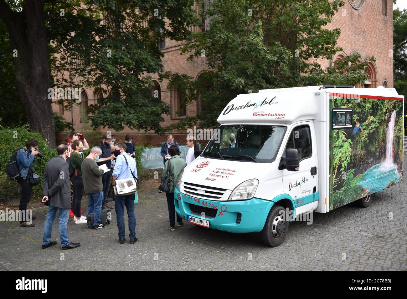 Berlin, Germany. 15th July, 2020. During the visit of Elke Breitenbach (Die Linke, r), Social Senator of Berlin, journalists stand in front of the shower mobile for homeless women on Leopoldplatz, which is operated by the Sozialdienst katholischer Frauen e.V. Credit: Sven Braun/dpa/Alamy Live News Stock Photo
