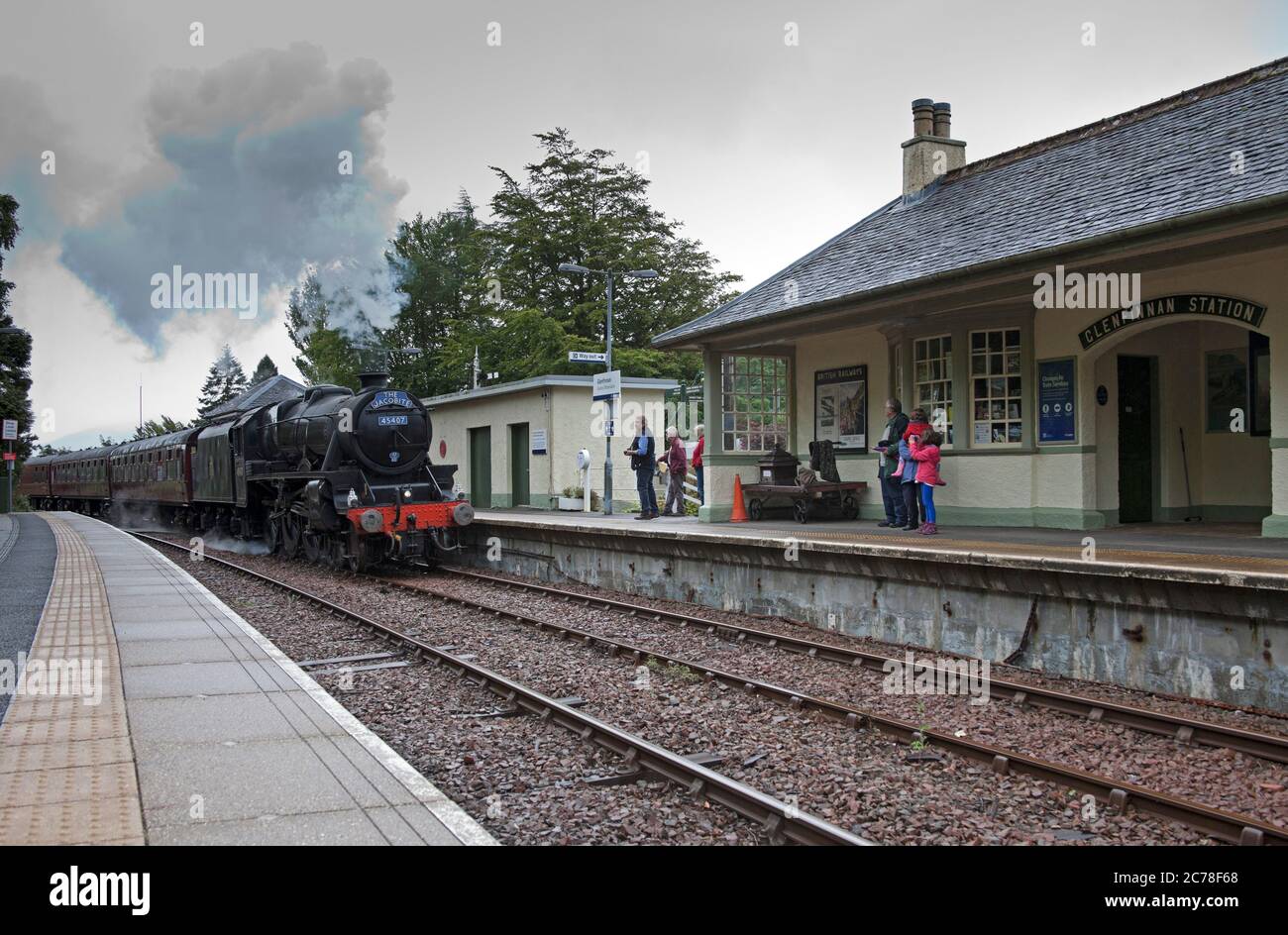Jacobite Steam Train, Lochaber, Scotland, UK. Glenfinnan Station, 15 July 2020. The delayed service of the Jacobite Steam Train due to the Covid-19 Coronavirus Lockdown runs for the first time in 2020. This 84 mile round trip winds past a list of impressive scenic and historic views. Pictured: Steam train entering Glenfinnan Railway  Station. The service would normally begin its Easter Service around 30th March but  due to the pandemic it had to be postponed until the Scottish Government decided it was safe to move into Phase 3. Stock Photo