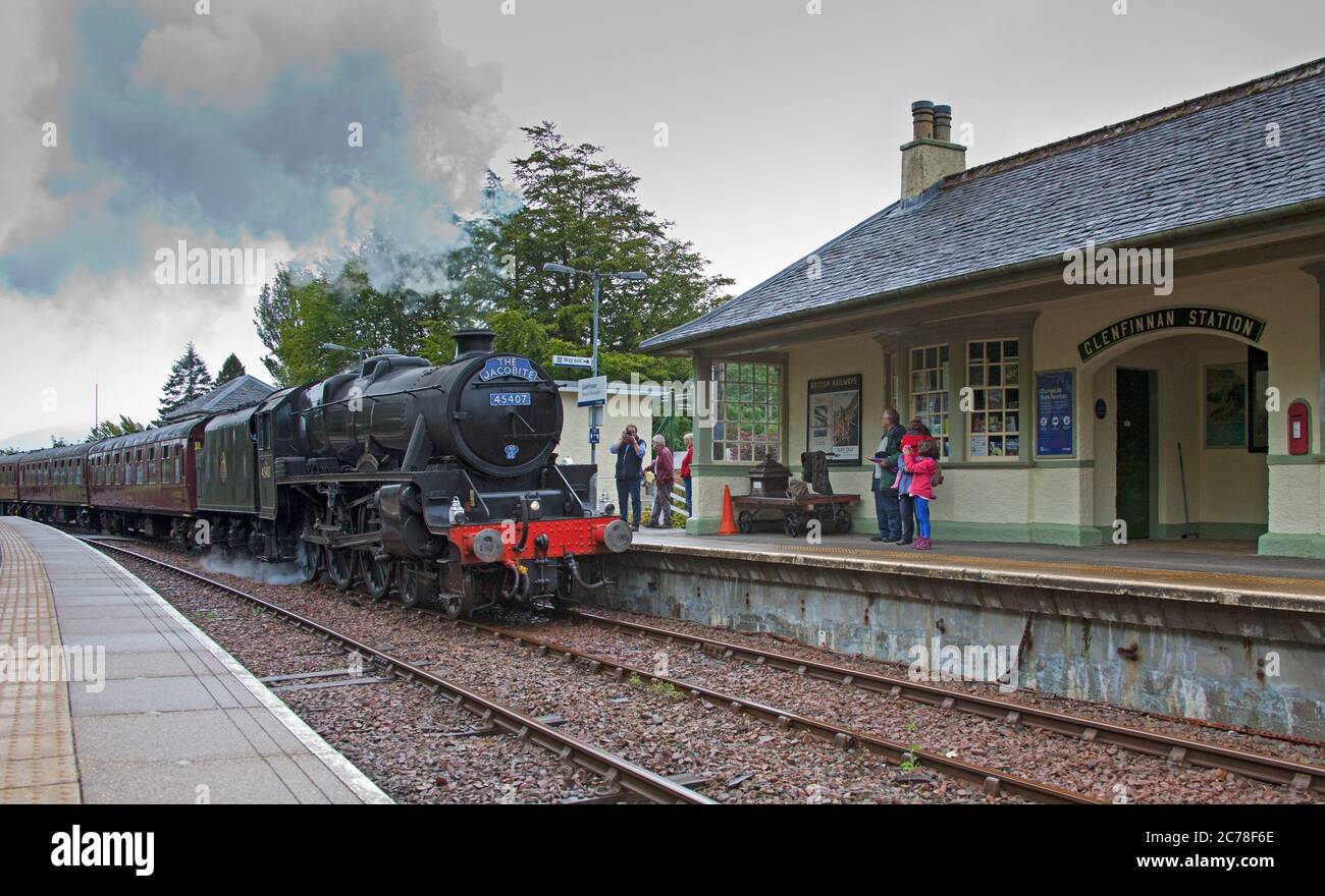 Jacobite Steam Train, Lochaber, Scotland, UK. Glenfinnan Station, 15 July 2020. The delayed service of the Jacobite Steam Train due to the Covid-19 Coronavirus Lockdown runs for the first time in 2020. This 84 mile round trip winds past a list of impressive scenic and historic views. Pictured: Steam train entering Glenfinnan Railway  Station. The service would normally begin its Easter Service around 30th March but  due to the pandemic it had to be postponed until the Scottish Government decided it was safe to move into Phase 3. Stock Photo