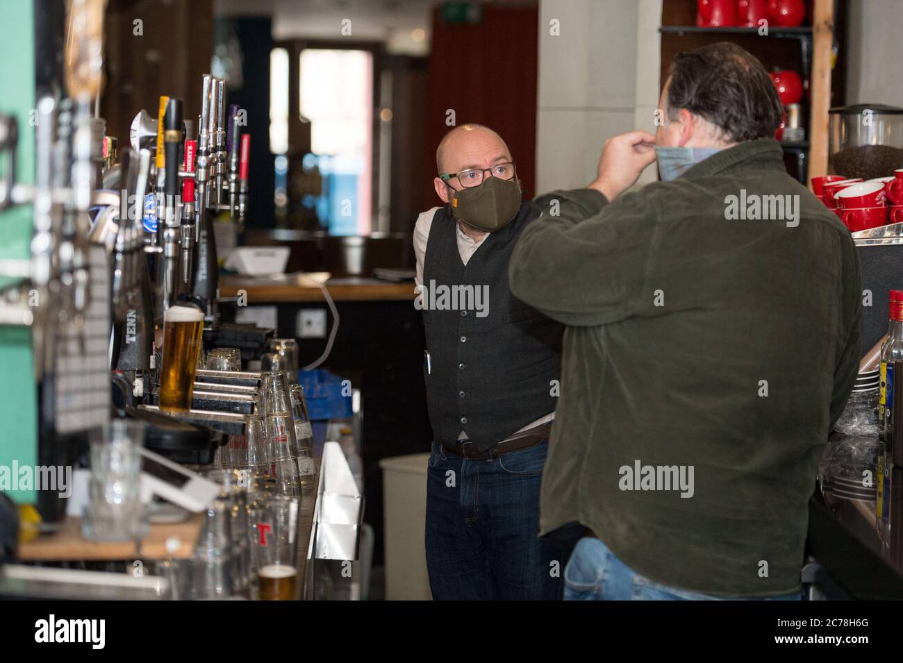 Glasgow, Scotland, UK. 15th July, 2020. Pictured: Scottish Greens Co-Leader Patrick Harvie MSP seen visiting Phillies of Shawlands as the neighbourhood bar reopens following the easing of lockdown restrictions. Patrick is shown the work the venue has undertaken in advance of reopening to deal with the continuing coronavirus threat and discusses his campaign for fair work conditions in the hospitality sector. Credit: Colin Fisher/Alamy Live News Stock Photo