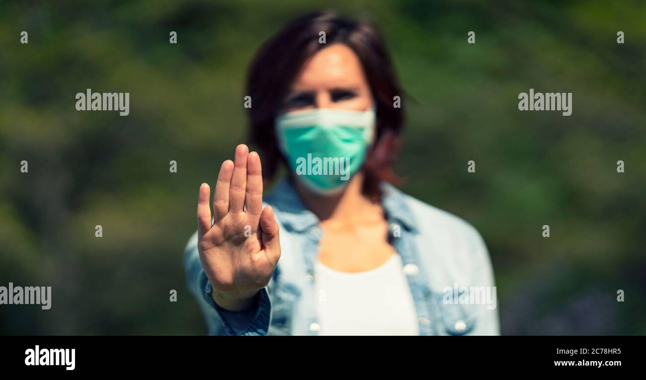 Beautiful woman wearing medical mask outdoor Stock Photo