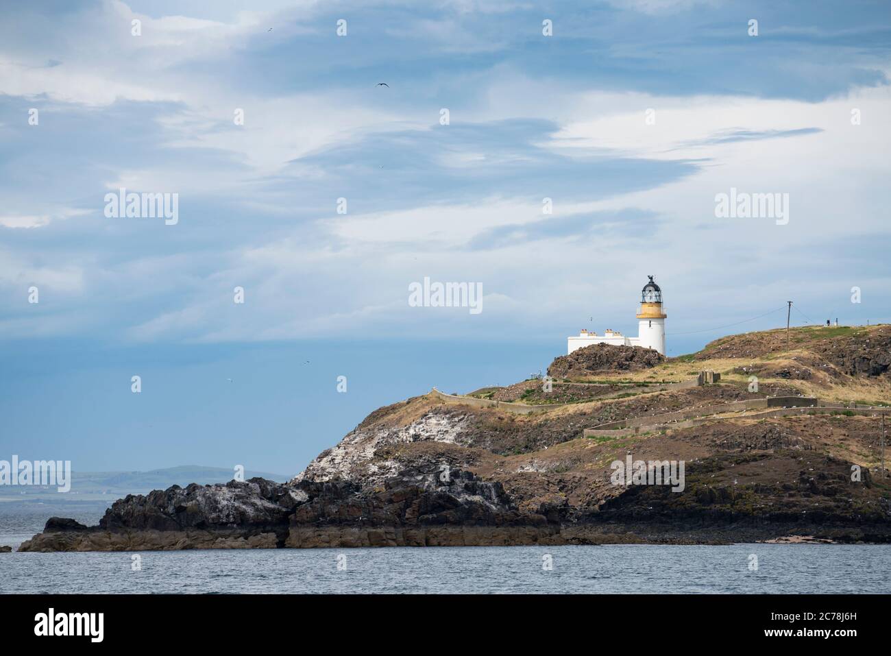 View of lighthouse on Fidra Island in Firth of Forth, off East Lothian coast, Scotland, UK Stock Photo