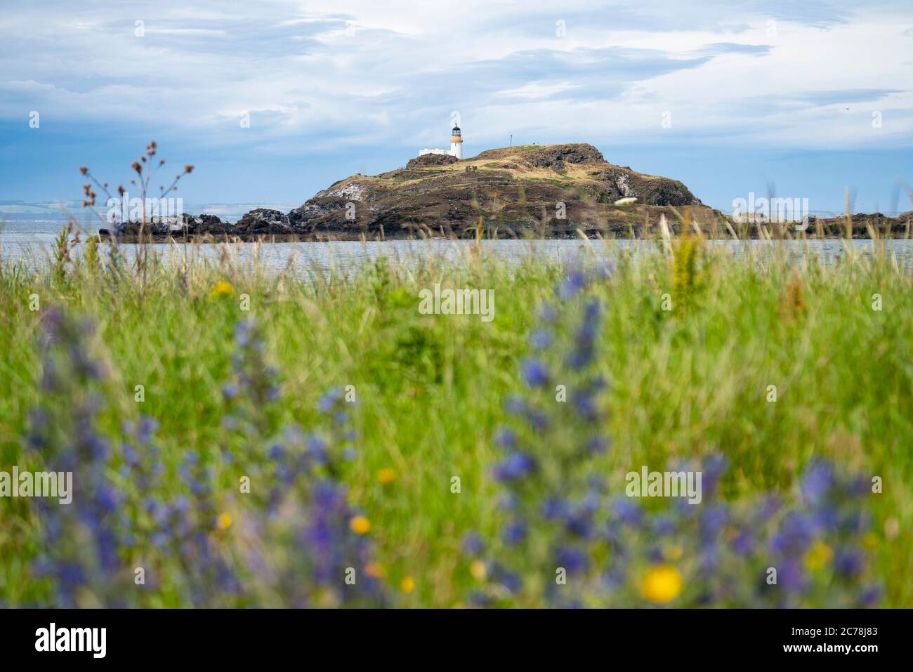 View of lighthouse on Fidra Island in Firth of Forth, off East Lothian coast, Scotland, UK Stock Photo