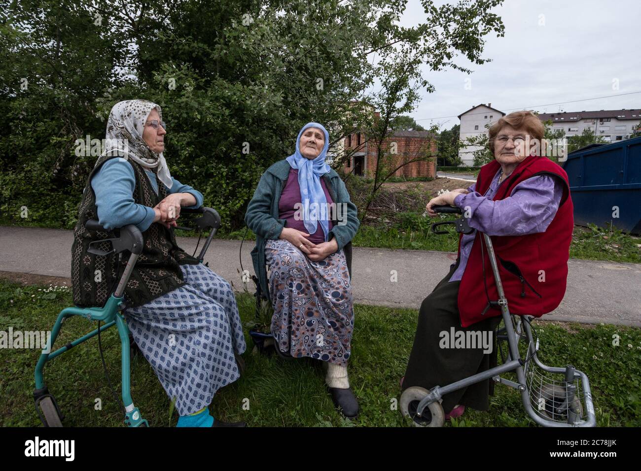 BRCKO, BOSNIA, MAY 6, 2017: Senior Bosniak Women, wearing the traditional muslim scarf, sitting and discussing among friends in the streets of the Bos Stock Photo