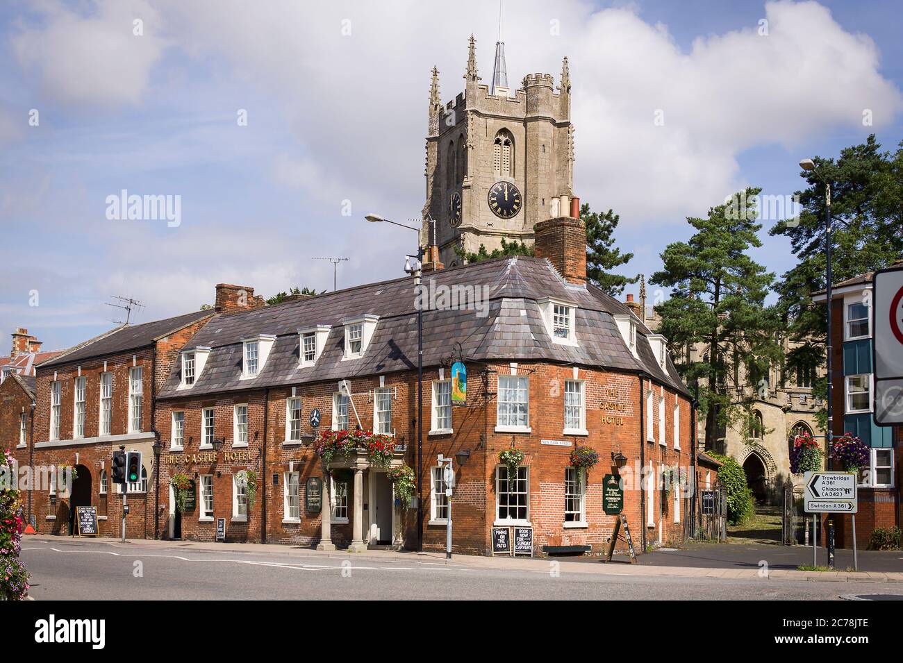 The Castle Hotel in Devizes Wiltshire England UK with a church tower and clock in the background Stock Photo