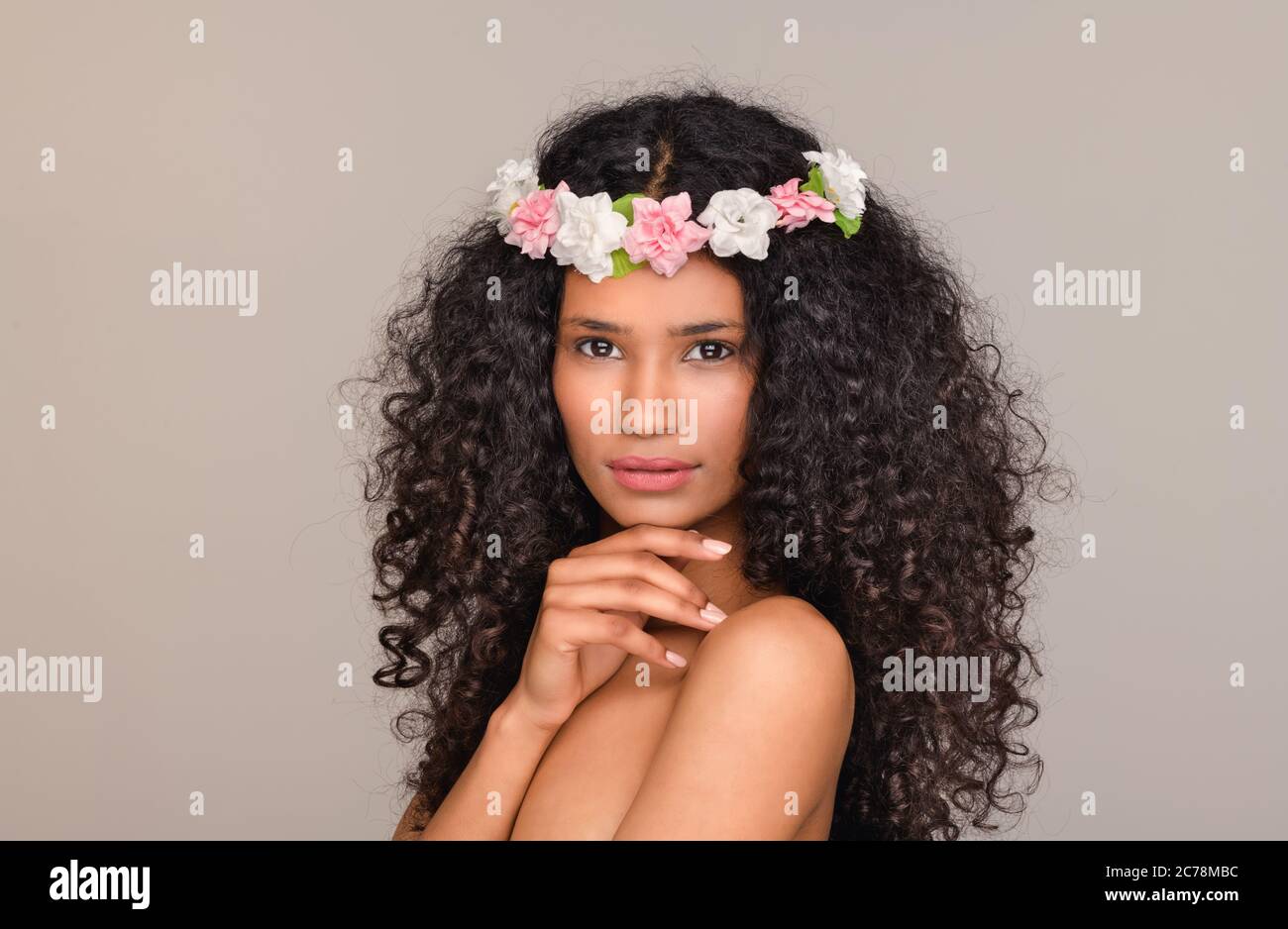 Santo Domingo Girl In Her Early Twenties Wearing A Chaplet Of Pink And White Flowers On Her Thick Curly Black Hair As She Looks At The Camera With Han Stock Photo