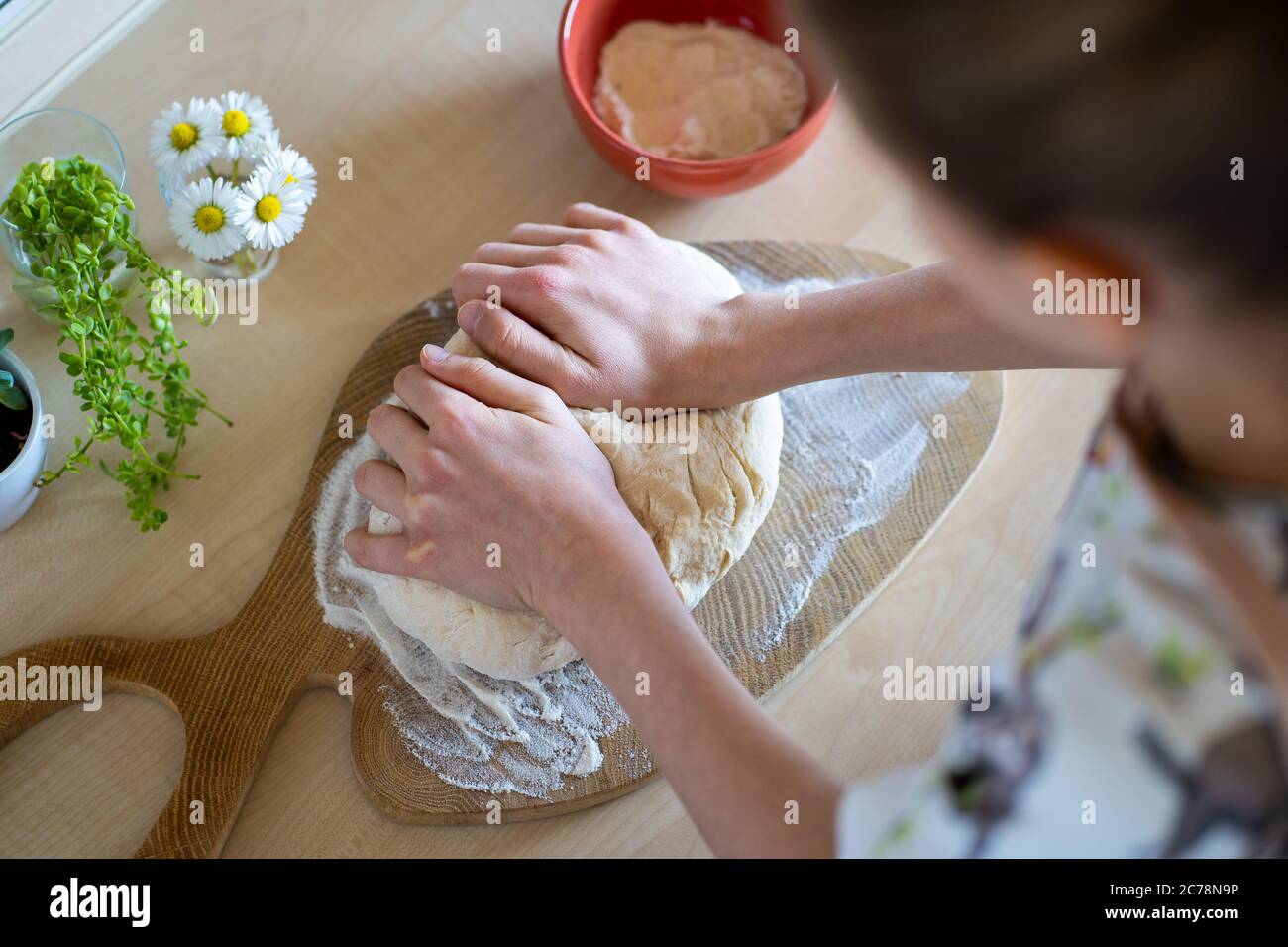 Kid is making, easy to prepare and healthy, home made irish soda bread. Home bakery. Stock Photo