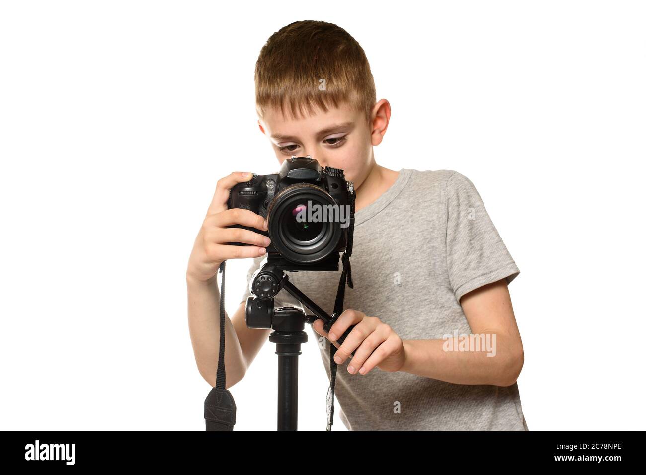 Schoolboy shoots video on DSLR camera. Front view. White background, isolate Stock Photo