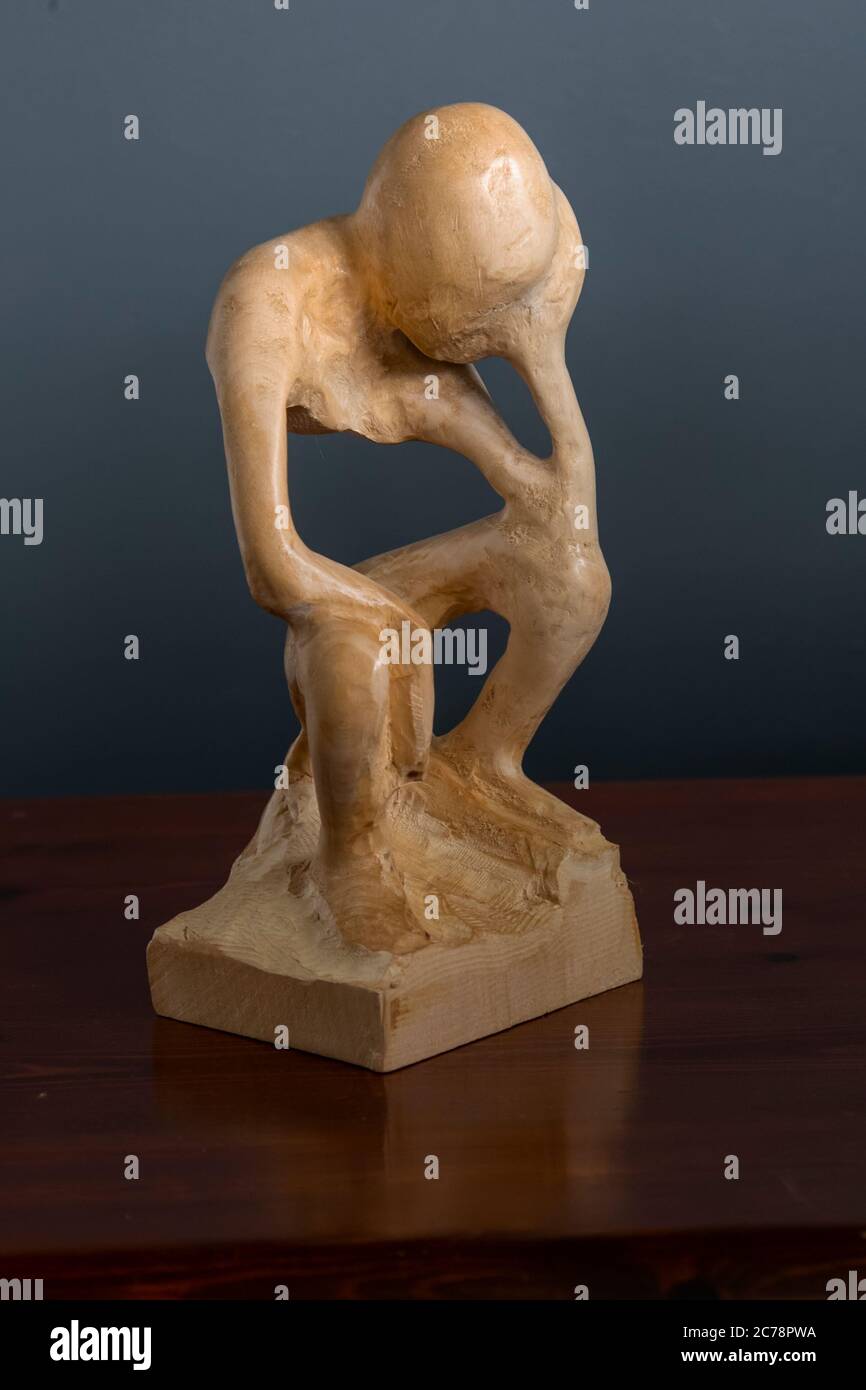 Artistic wood carving of a person in torment and anguish by Judy Tadman using minimalist representation of the human form Stock Photo